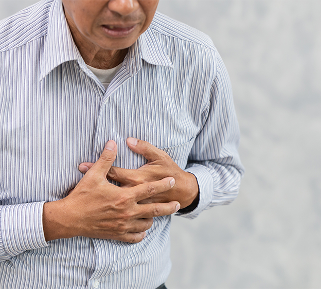 Older man grabbing his chest and making a grimaced face