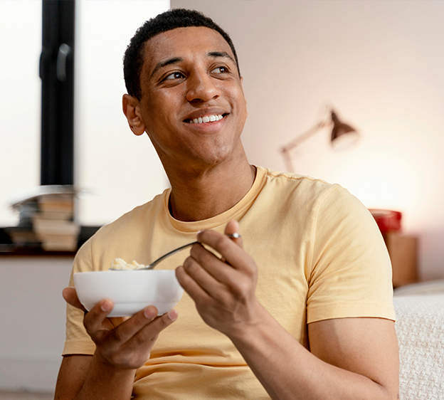 Man at home eating a bowl of cereal