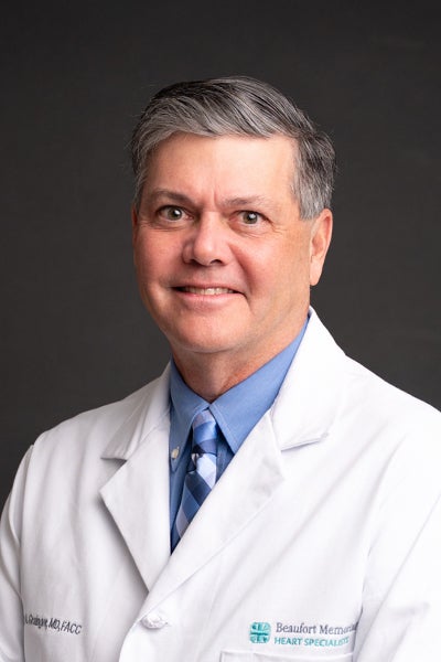 Professional portrait of Terry Grainger, MD, FACC in a white lab coat with the Beaufort Memorial Heart Specialists logo on the left chest panel