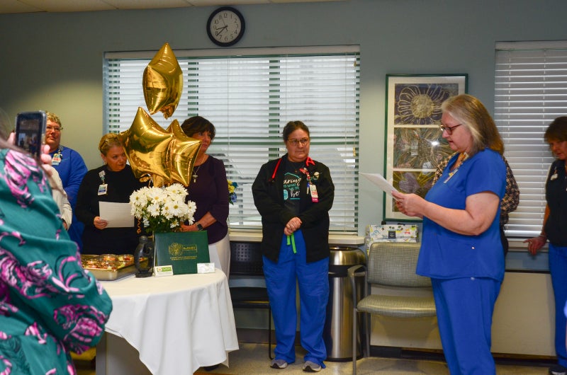 Beaufort Memorial ICU nurse Canice Chappell listens on as a colleague reads DAISY Award nominations to her.