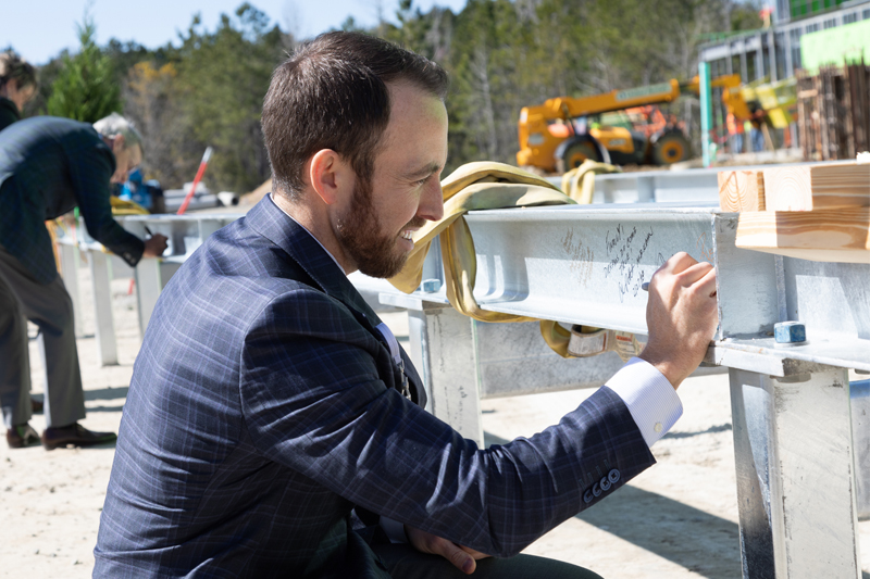 Russell Baxley signing the beam at the topping off ceremony for Okatie Medical Pavilion