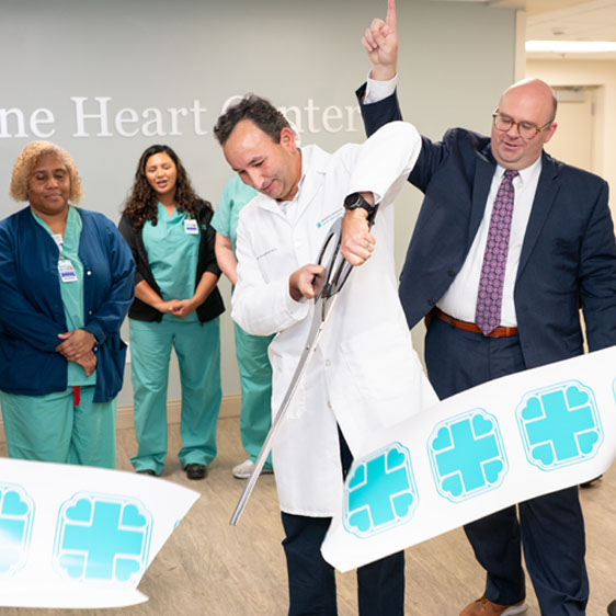 Dr. Smalheiser cuts ribbon to unveil renovated cath lab