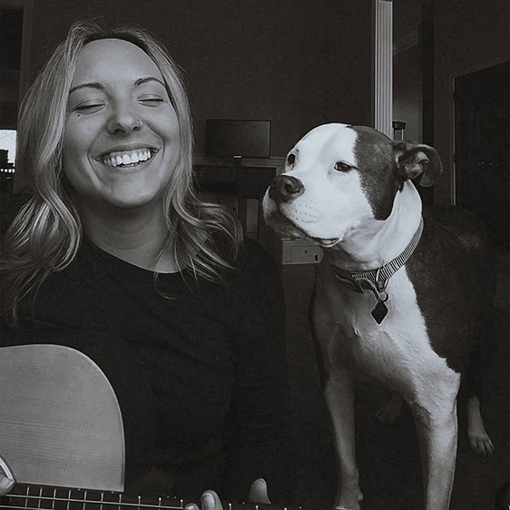 A black and white photograph of Samantha Bruns and her dog Zella