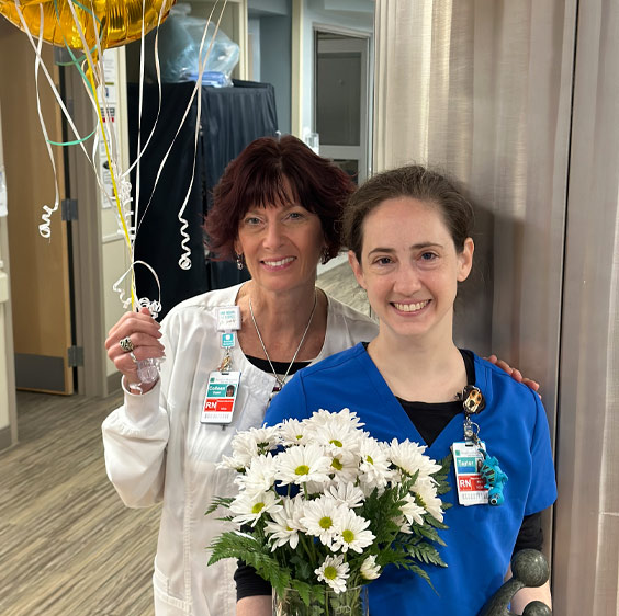 Nurse Practictioner Taylor Robinson photographed receiving the The DAISY Award for Extraordinary Nurses standing with other Beaufort Memorial staff