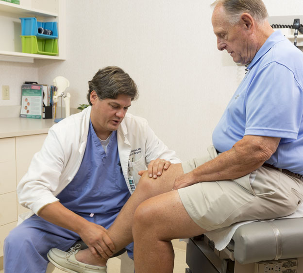 Dr Blocker examines a patient's arthritic knee