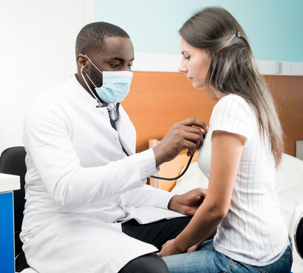 Doctor checking a woman's heartbeat