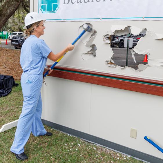 Dr. Tara Grahovac participates in the wallbreaking ceremony