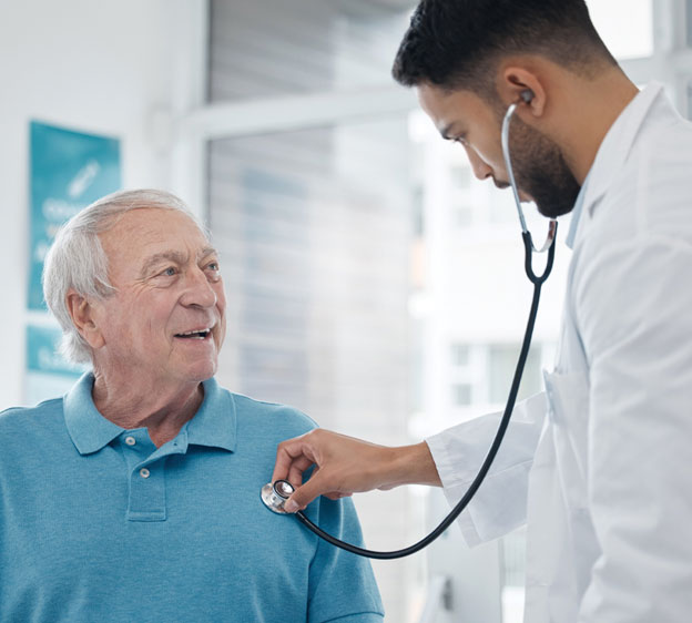 Man having his heart rate checked by a medical professional with a stethoscope and wearing a white coat