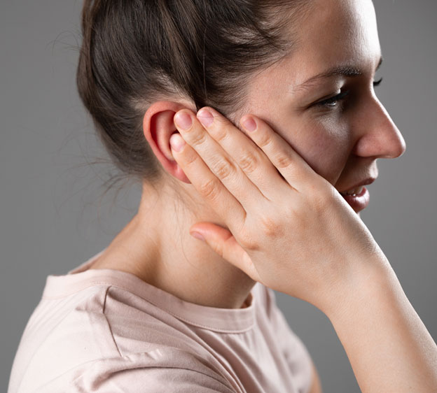 Woman holding her ear in pain