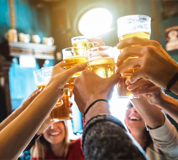 Young adults toasting at a bar