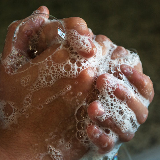 soapy bubbles covering hads while washing