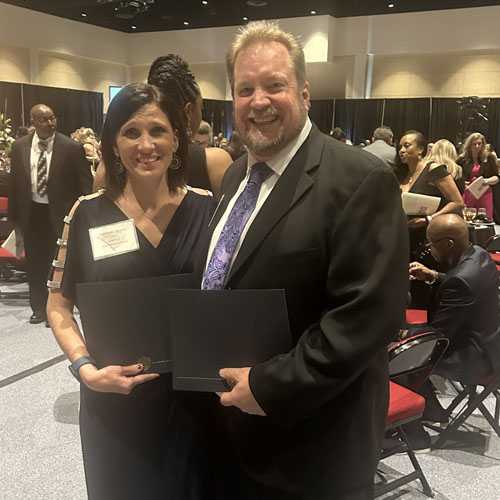 Jaime Cuff, NP, stands next to Kevin Kremer, RN