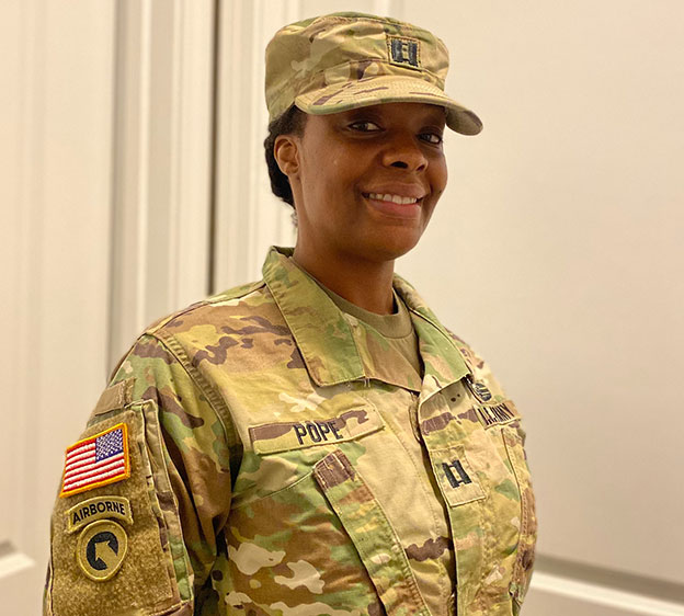 A National Guard solider named Connie Pope posing for a photo in her uniform