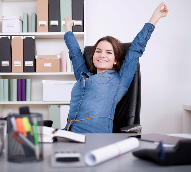 Woman stretching while sitting at her desk