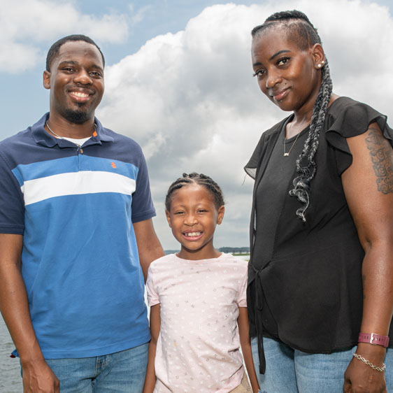 Breast cancer survivor Claudia Holmes smiles with her son and daughter 