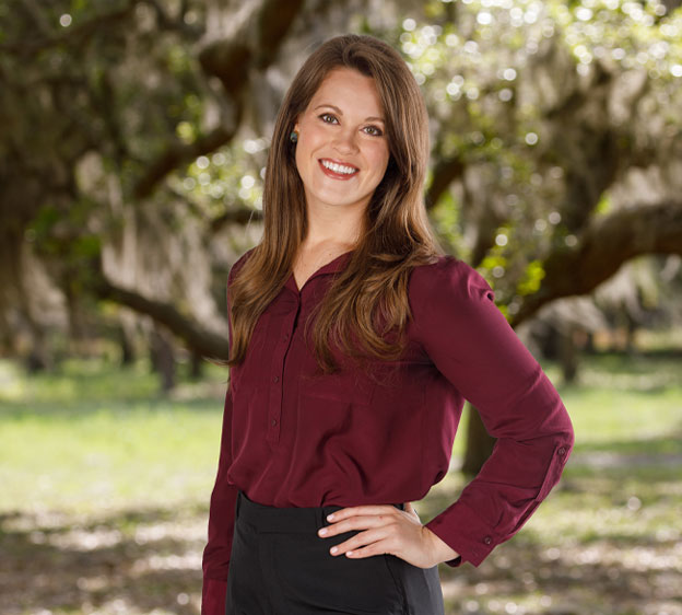 Tara Kay, MMS, PA-C, poses for a photo standing under a tree