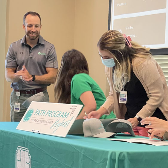 Employee signs PATH commitment letter during ceremony 