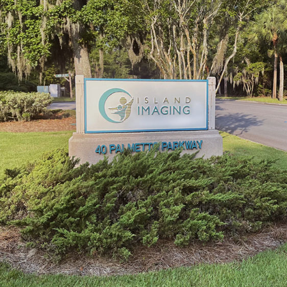 Island Imaging monument sign surrounded by greenery