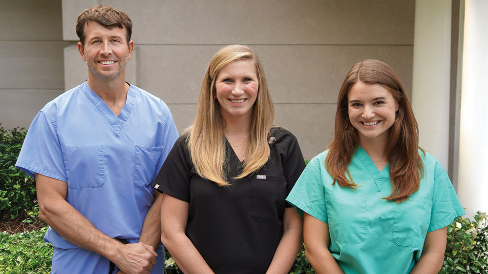 Dr. Louis Plzak and physician assistants Kristin Callaghan and Nancy Thomas pose outside the Beaufort Memorial Urology Specialists office building