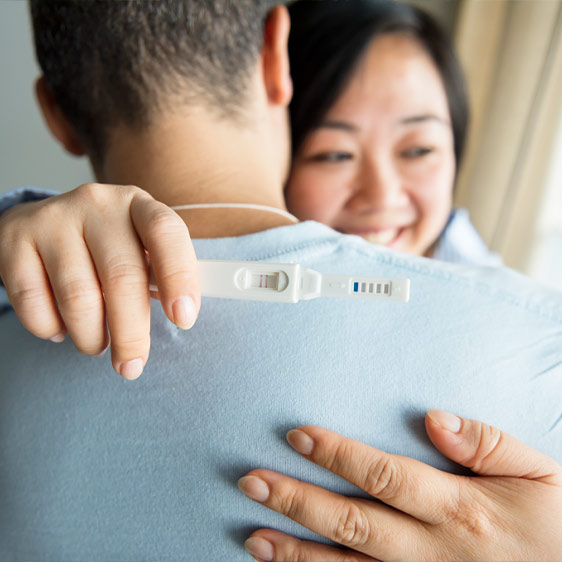 Pregnant woman hugging her partner