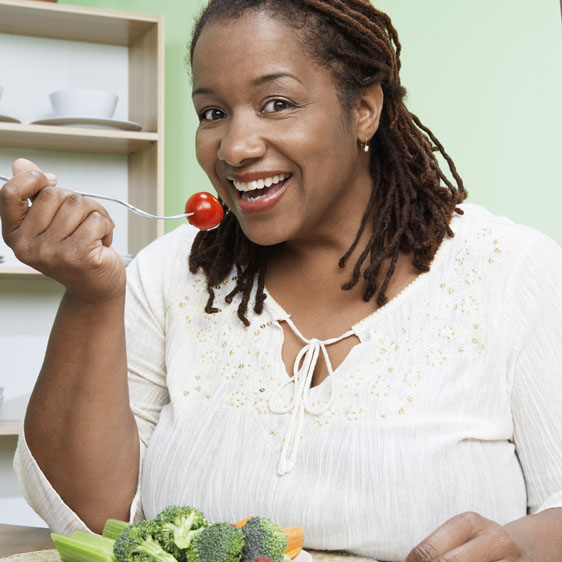 woman eating a tomato