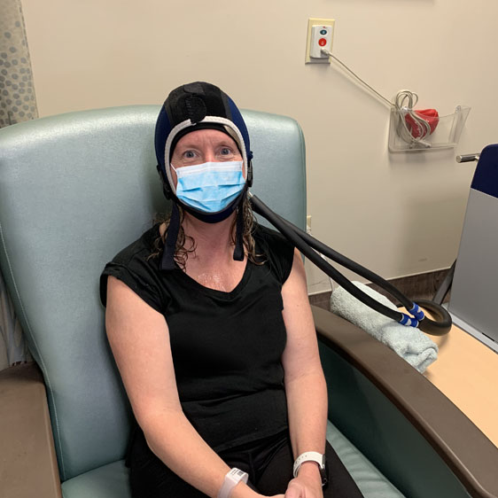 Melanie Williams wearing her DigniCap while receiving a chemotherapy infusion at Beaufort Memorial.