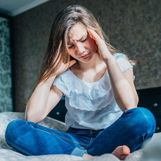 Young woman holding her head