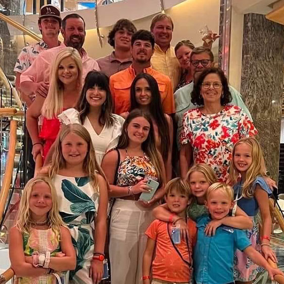 Carol Thames and Chelsey Bates photographed with their extended family, all posing on stairs for a family photo