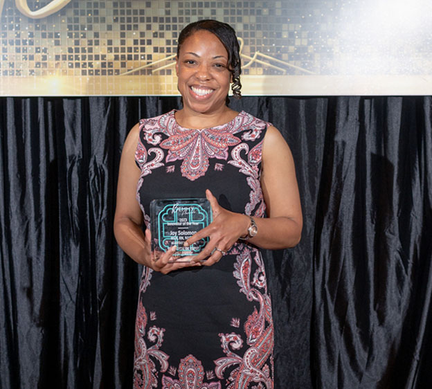 Joy Solomon poses with her Bemmy Award for Innovator of the Year