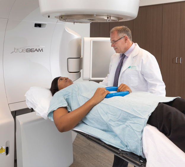 Dr. Jonathan H. Briggs, a radiation oncologist, performing a scan on a patient.