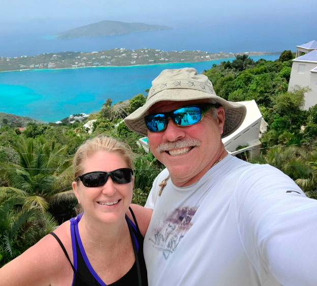 John Aust photographed with his wife, Kim, and smiling at the camera