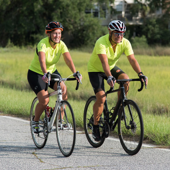 Dr. Wallace and her husband cycling along the edge of the salt marsh