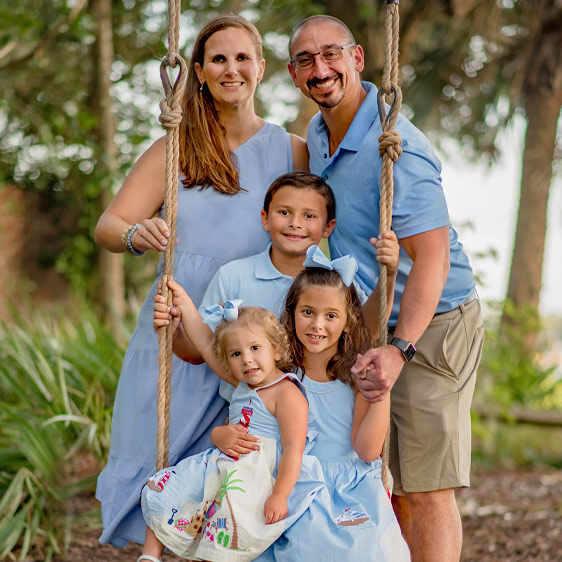 Beaufort Memorial primary care provider Kimberly Bean, MSN, FNP-C, smiles at the camera while standing outdoors with her family