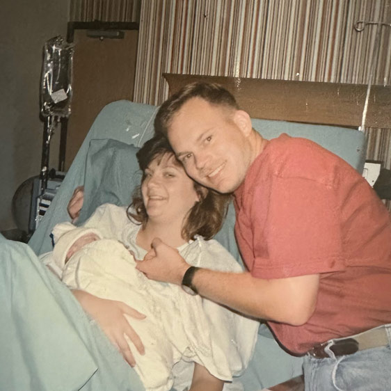 A photograph of a mother and father posing after the birth of their daughter, Shannan