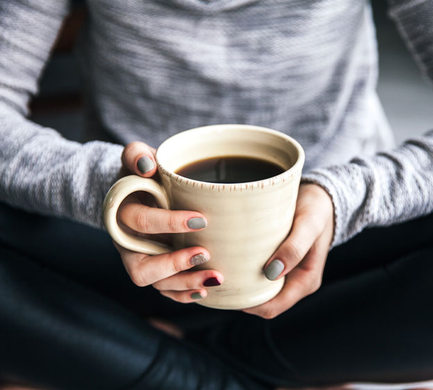 person holding a mug of coffee