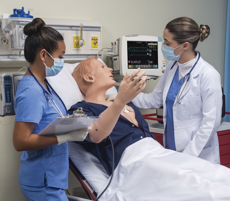 nursing students interacting with patient simulation manikin