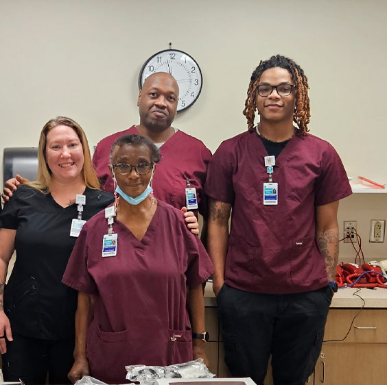 Jaysun Puryear photographed with three other Beaufort Memorial employees