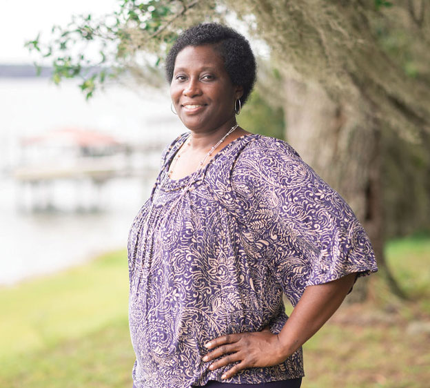 Cheryl Fields wearing a blouse looking toward the camera and smiling