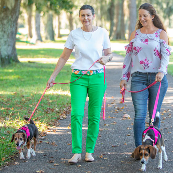 A woman with cancer and her friend walk their dogs together