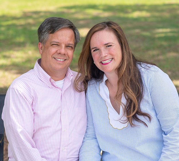 Drs. William and Michelle Bens Clare sitting together outdoors