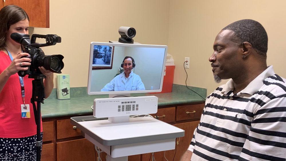 patient speaks with cardiologist via telehealth technology