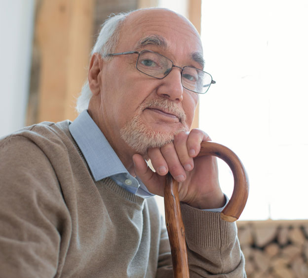 Older man sitting in front of a window