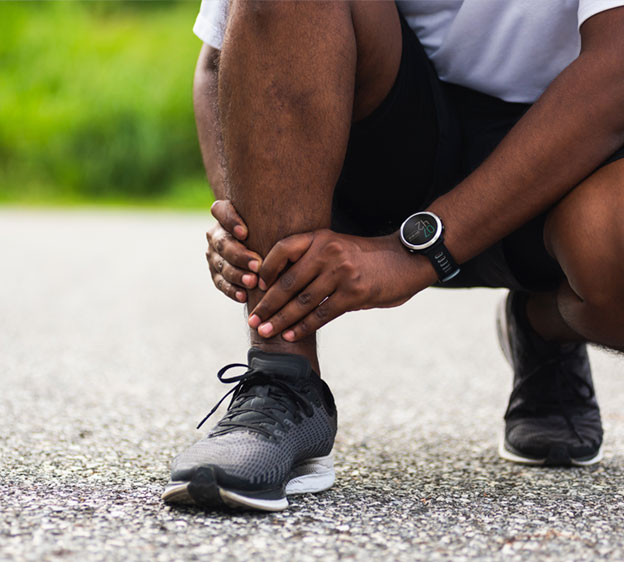 Man holding his ankle in pain