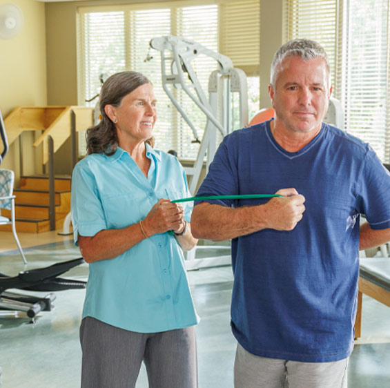 Beaufort Memorial physical therapist Tracy Lovett works with an older male patient.