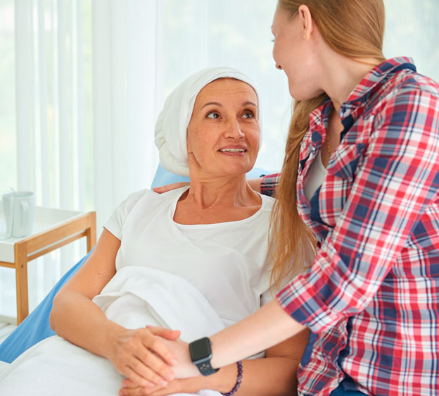 Young woman comforting a woman with cancer