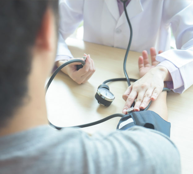 A health care provider takes a patient&rsquo;s blood pressure.