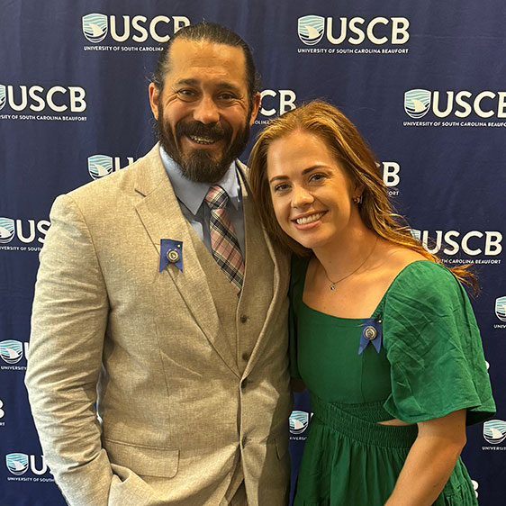 Adam Flores, BSN, on the left, and Olivia Pace, BSN, on the right, photographed at the University of South Carolina Beaufort graduation