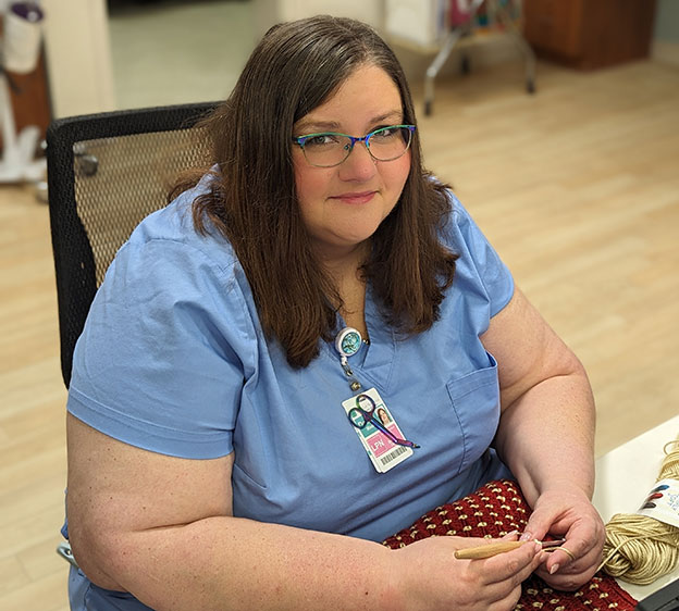 Donna Mixon, LPN, with the Beaufort Memorial Collins Birthing Center, poses with her crochet tools.