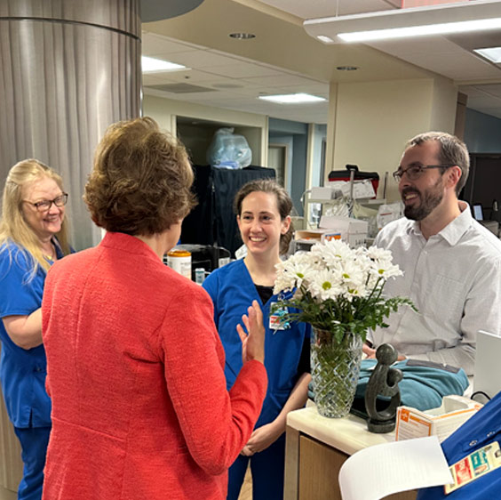 Nurse Practictioner Taylor Robinson photographed receiving the The DAISY Award for Extraordinary Nurses standing with other Beaufort Memorial staff