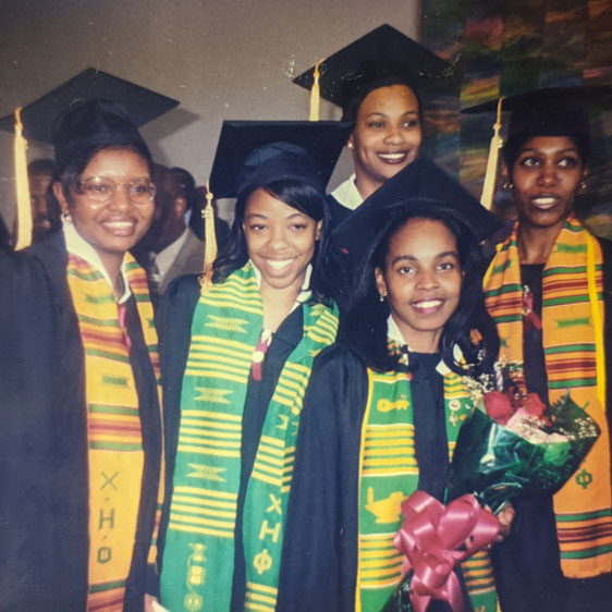 Joy Solomon poses with classmates at college graduation